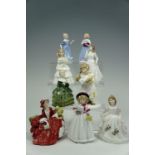 Nine Royal Doulton figurines including "What's the Matter?", tallest 15 cm