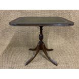 A George III influenced mahogany lamp table, having an inset gilt tooled green leather top and