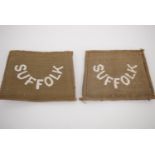 A pair of Great War Suffolk Regiment slip-on cloth shoulder titles