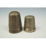A Charles Horner silver thimble together with another in white metal, also by Horner