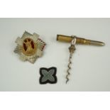 A "bullet" corkscrew, Royal Scots cap badge and rank pip