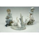 Three NAO figurines; a clown, a boy with rabbit, and geese, (boy a/f)