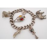 A silver charm bracelet with heavy cast silver elephant, swan and other charms, 69 g