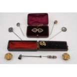 A group of Victorian costume jewellery including horseshoe, US Coin, knot and serpentine stick pins,