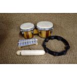 A quantity of percussion and wind instruments including bongos, tambourine, rattles etc