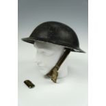 A Second World War British steel helmet shell together with a brass "Tommy" cigarette lighter
