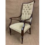 An Edwardian upholstered mahogany open armchair, having tapering reeded front legs, 109 cm high