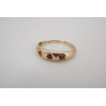 A vintage 9 ct gold finger ring gypsy set with three small garnets, L, 1.1 g