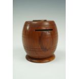 A treen barrel-form money box mounted with a Edward VII penny, 8 cm