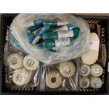 A box of vintage new old shop stock containing bobbins of thread, wool, string etc.