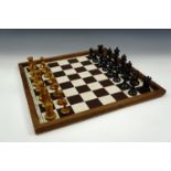 A late 19th / early 20th Century Staunton chess set (king's 10 cm) with a board