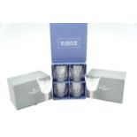 A boxed set of four Waterford Crystal Marquis whisky tumblers together with a pair of Lismore