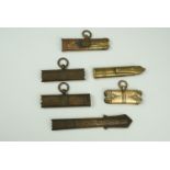 A group of sword scabbard brass lockets and chapes