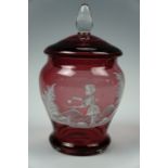 A Mary Gregory enamelled cranberry glass lidded jar, 18 cm tall