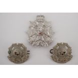 A Border Regiment Staybrite cap badge together with a pair of other ranks' collar badges