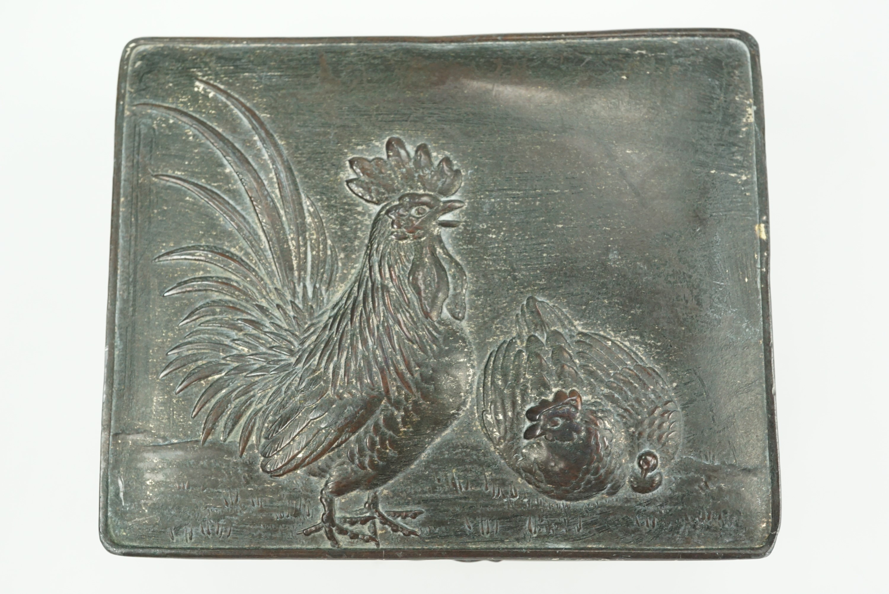 A small early 20th Century Japanese EPBM trinket box, its lid relief decorated in depiction of a