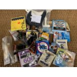 A quantity of acoustic and electric guitar strings, plectrums and other guitar accessories