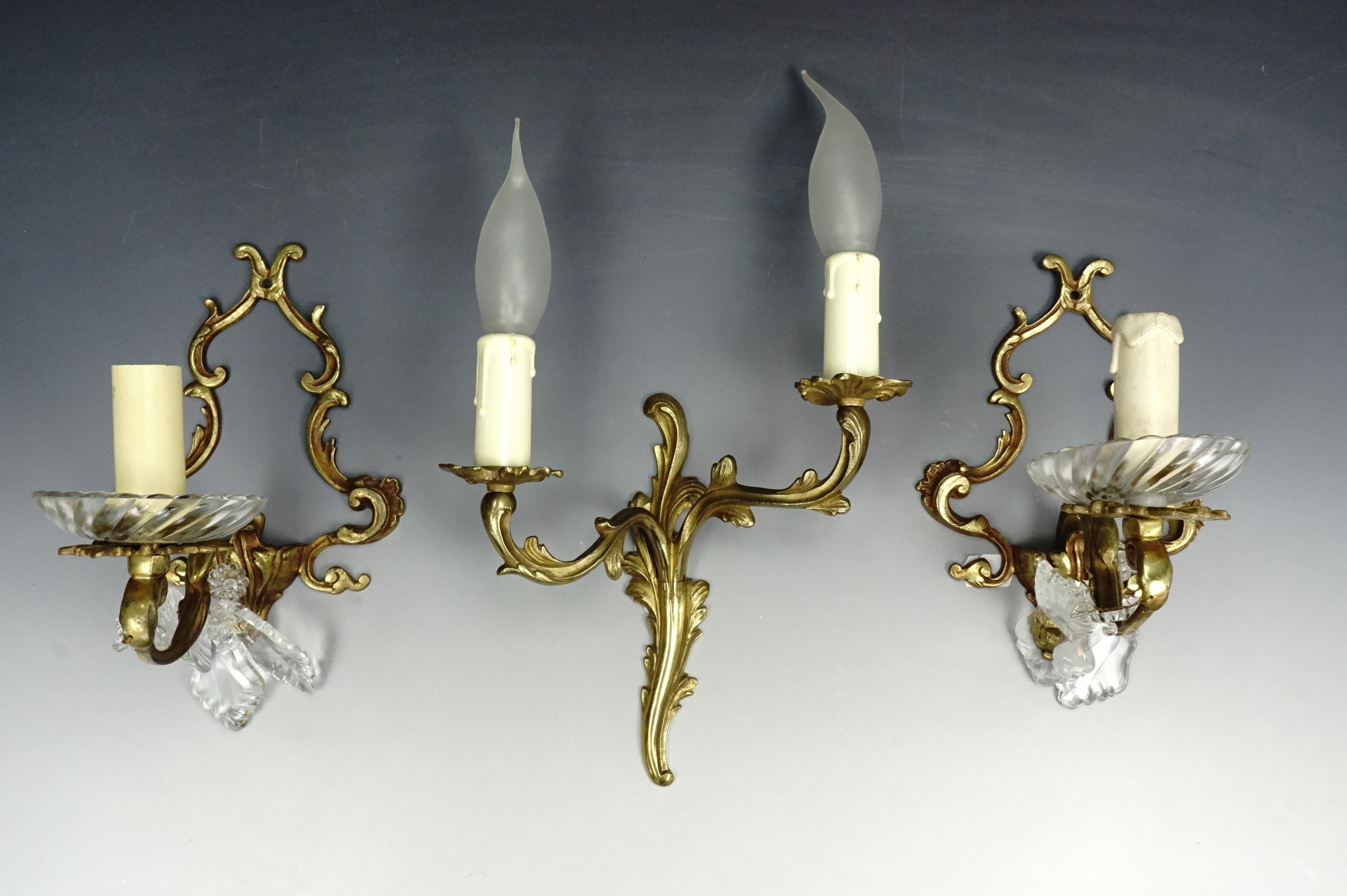 A pair of Baroque influenced brass and glass sconces, together with a Rococo example, 20 cm