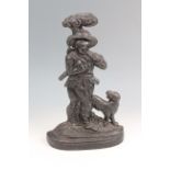 A Victorian cast iron door porter modelled as a woodsman and his hound, 38 cm