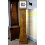 A fine Art Deco walnut grandmother clock, the pendulum movement striking on gongs and having a