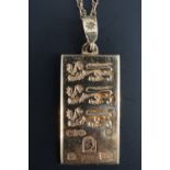 A 1/4 oz 9 ct gold "three lions" ingot pendant, and fine link neck chain, 9.7 g