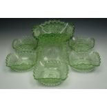 A set of six emerald flashed cut glass bowls together with a larger similar bowl