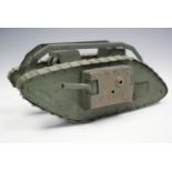 A fine Great War period hand-made brass model / toy British Mk I "male" tank, green painted, given