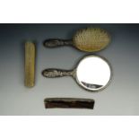 A four piece silver dressing table brush set