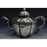 A late Quing Chinese export silver teapot, of shouldered lobed / melon form