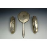 A three piece silver dressing table set