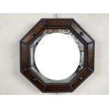 A small George V oak octagonal wall mirror, 41 cm