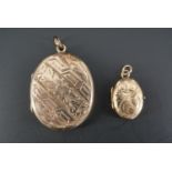 A Victorian yellow metal oval locket decorated with banded foliate and fern decoration, 30 mm x 25