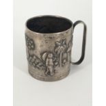 A late 19th / early 20th Century Asian white metal cup, repouse worked and engraved in depiction