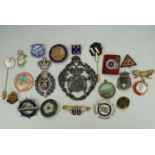 A group of vintage badges and medallions including a Filey Butlins enamelled lapel badge, a "The