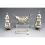 A late Victorian silver salt cellar, of Georgian gadrooned navette form, together with a pair of
