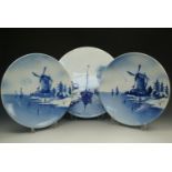 Three large decorative blue and white plates, largest 35 cm