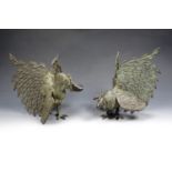 A pair of patinated cast brass figurines of fighting cocks, 22 cm