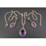 A white metal and amethyst demi parure comprising a pendeloque pendant and neck chain, together with