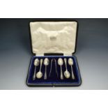 A cased set of six ribbed Hanoverian pattern silver coffee spoons with sugar tongs, Sheffield, 1919