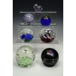 Two Caithness paperweights and four other glass weights