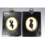A pair of 19th Century silhouettes reverse painted on domed glass, depicting a young lady and