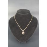 A Cairngorm smoky quartz and 9 ct gold pendant, with a 9 ct gold box link neck chain, 23 mm, 42