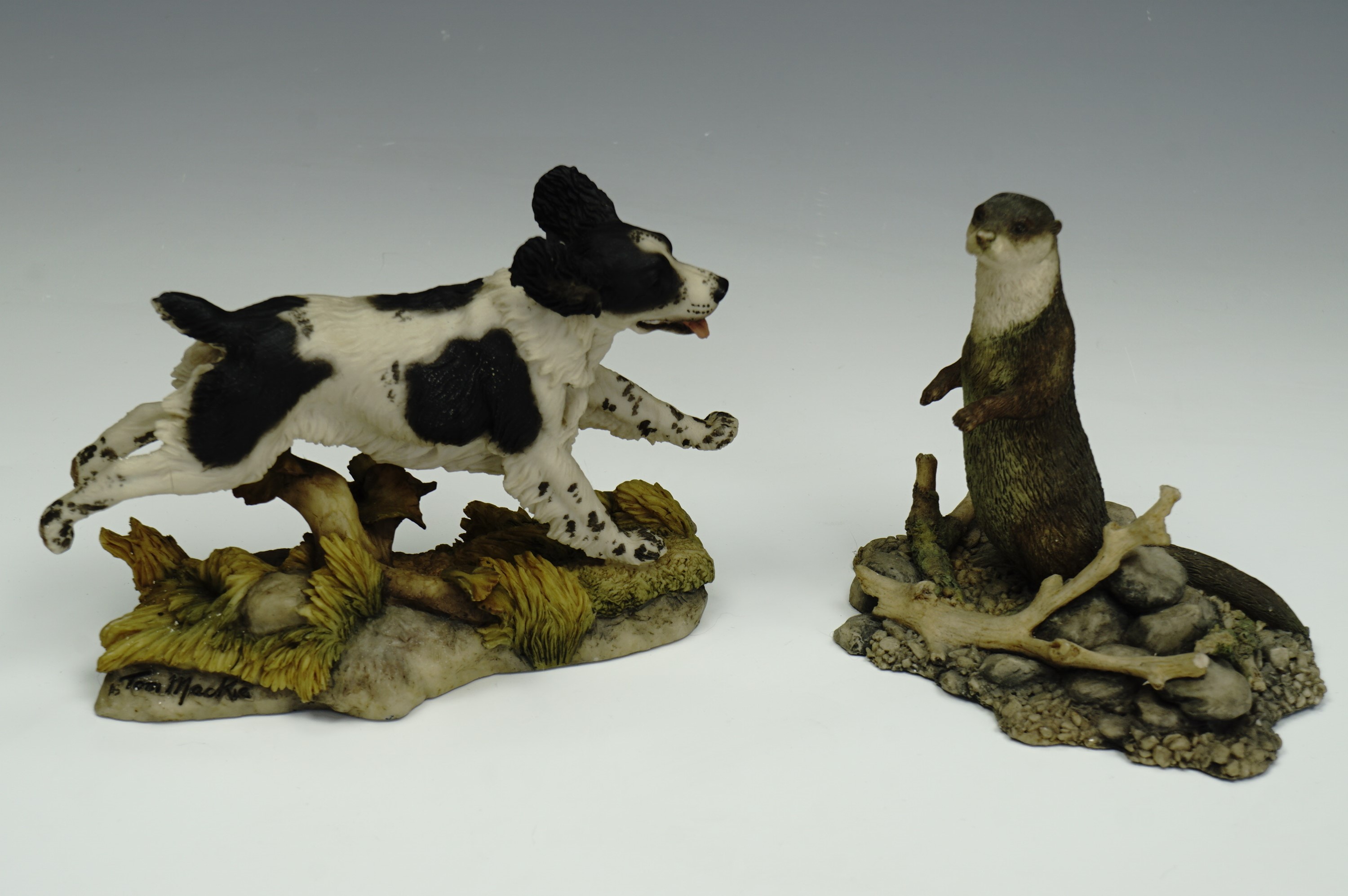 A Border Fine Arts figurine of an otter together with a dog by Teviotdale