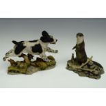 A Border Fine Arts figurine of an otter together with a dog by Teviotdale