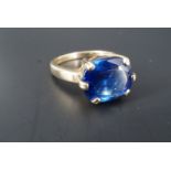 A blue topaz cocktail ring, the 4 mm x 5 mm stone claw-set on a 9 ct gold shank, size O