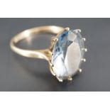 A vintage blue topaz and 9 ct gold finger ring, the oval facet-cut stone of approx 10 mm x 13 mm,