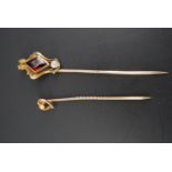 A late 19th / early 20th Century pearl and 9 ct yellow metal stick pin, its terminal in the form