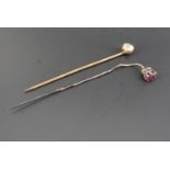 Two antique stick pins, respectively set with pink and white stones