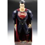 A large Superman 'Man of Steel' action figure in original packaging, 79 cm