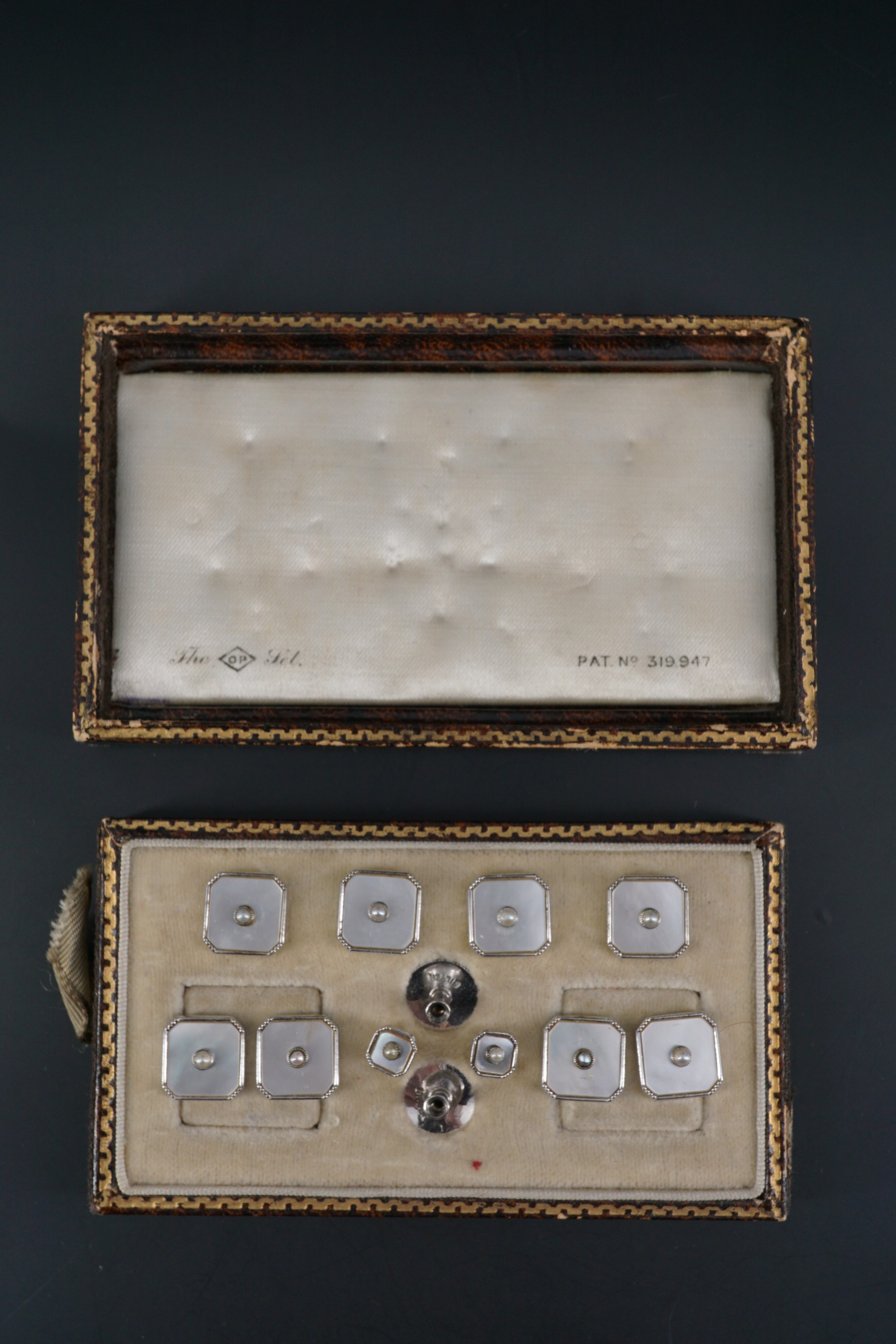 A vintage cased set of Art Deco influenced cuff links and shirt studs in seed pearl, mother of pearl